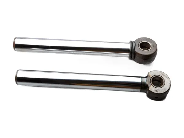 Two hydraulic piston rods on a white background: polished steel rod and forged eye end
