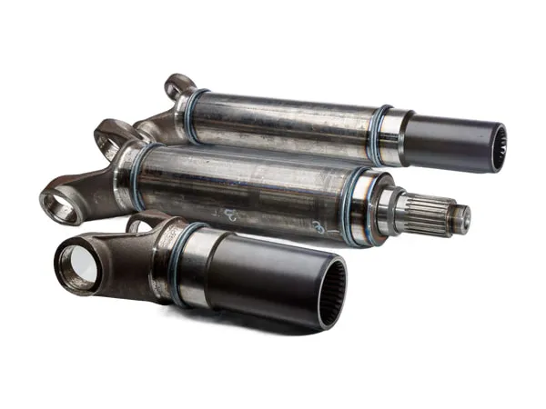 Three cardan shafts on a white background, with yoke end and splined connection