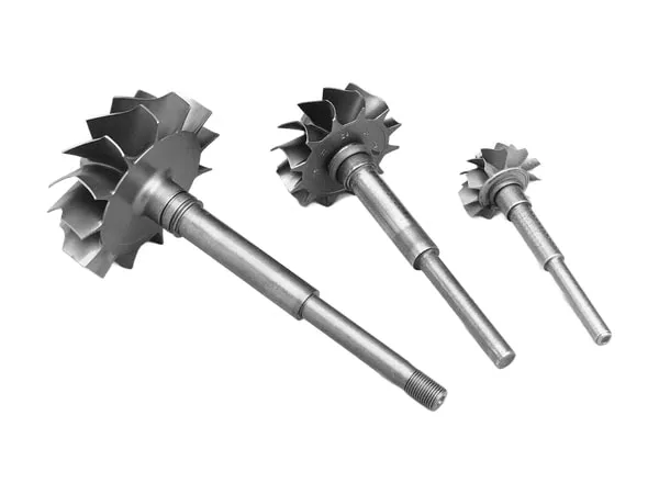 Three turbocharger turbine wheels of different sizes with shafts, on a white background