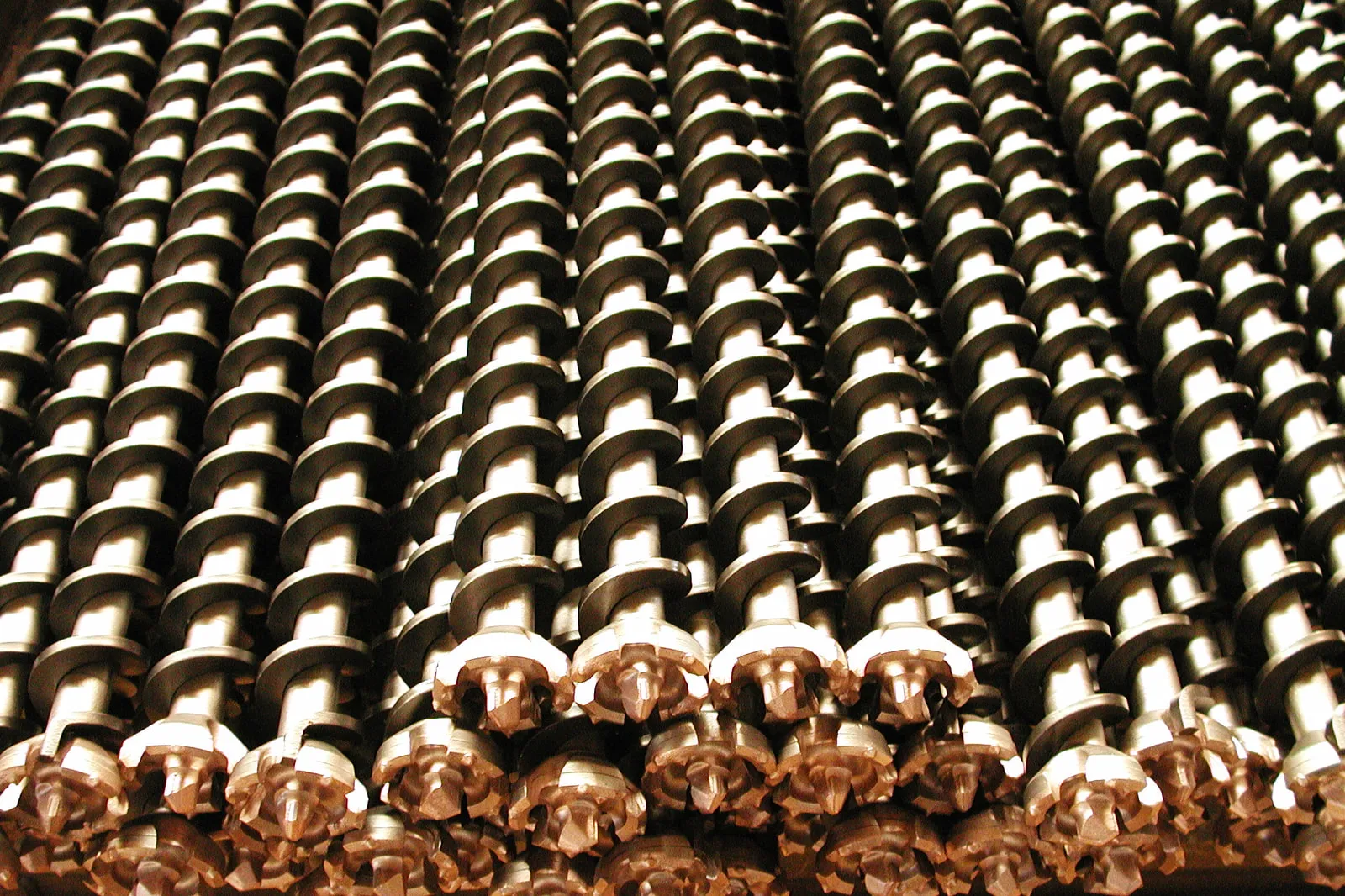 Friction-welded auger drill heads in series