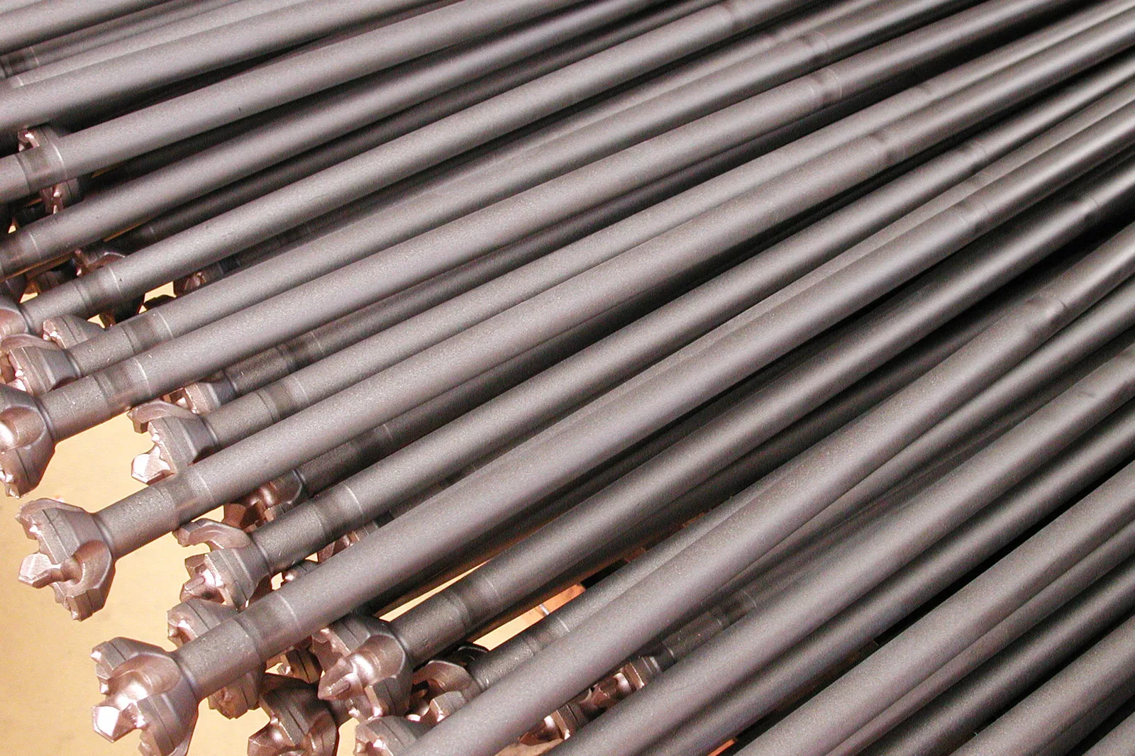 Friction-welded headed rods in series